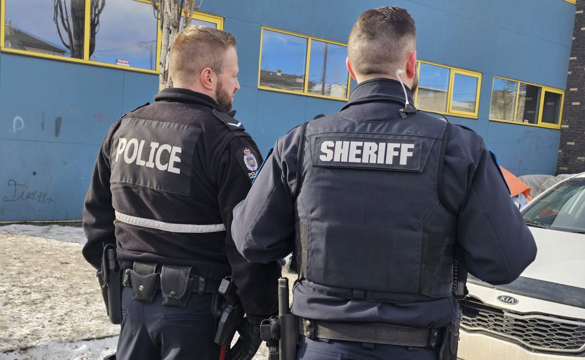 An Alberta Sheriff and Edmonton Police Service officer near a homeless encampment north of downtown Edmonton, Alta. on Thursday, March 2, 2023.