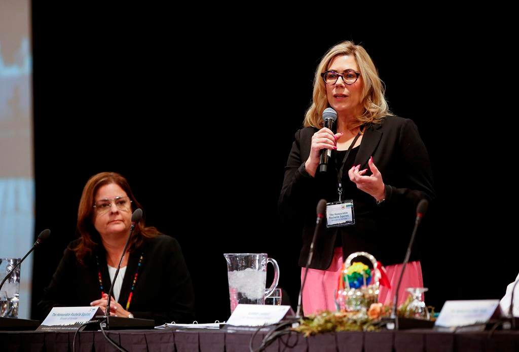 Manitoba Premier Heather Stefanson listens in as Rochelle Squires, minister of families, speaks at an event in Winnipeg on Tuesday, Jan. 31, 2023. 