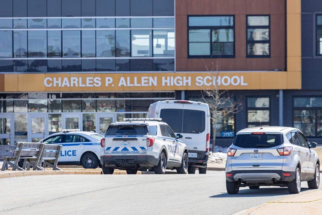 Police monitor the situation at Charles P. Allen High School in Halifax, Monday, March 20, 2023. A 15-year-old student accused of stabbing two staff members at a Halifax-area high school earlier this week remains in custody and is to return to court next month.