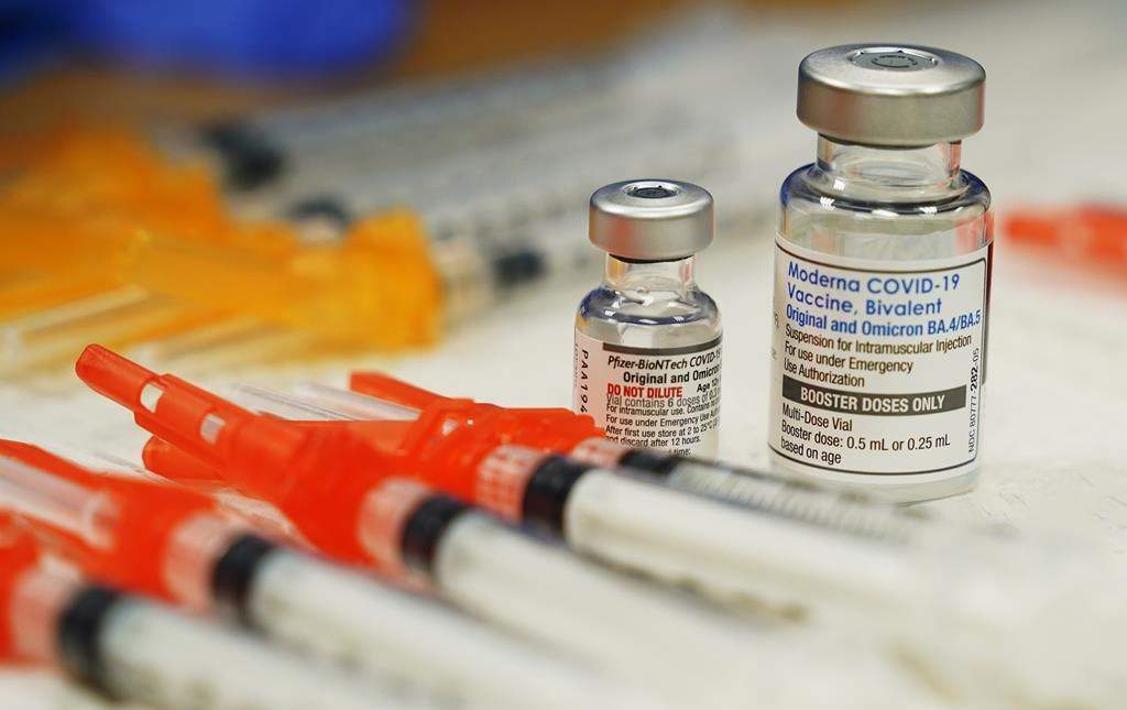 FILE - Pfizer, left, and Moderna bivalent COVID-19 vaccines are readied for use at a clinic on Nov., 17, 2022, in Richmond. Va. (AP Photo/Steve Helber, File).