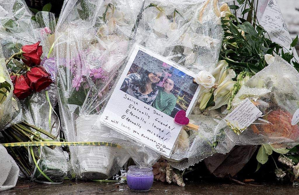 Flowers and messages are shown at a makeshift memorial near the site of the building, Thursday, March 23, 2023.