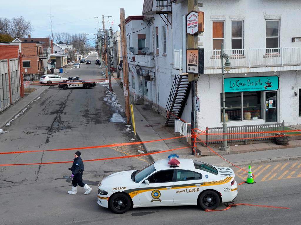 Police tape cordons off the scene after a Quebec provincial police officer was killed while trying to arrest a man in Louiseville, Que. on Tuesday.