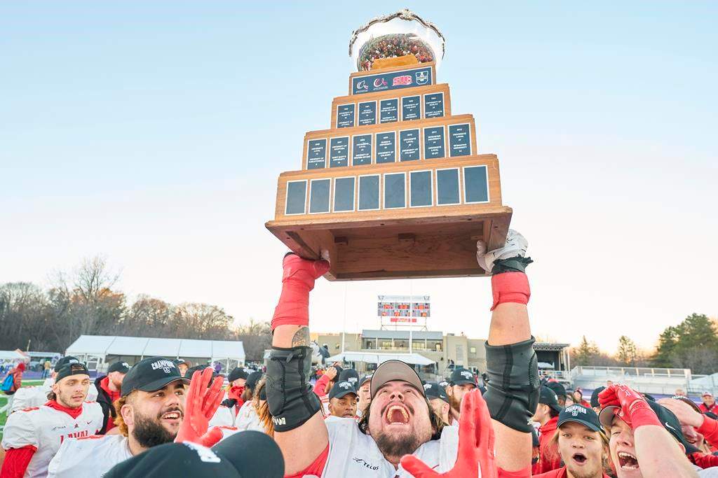 Laval’s Antoine Dean Rios hoist the Vanier Cup following the Rouge et Or’s victory over the Saskatchewan Huskies at Alumni Stadium in London, Ont., Saturday, Nov. 26, 2022. U Sports, Canadian university sport's governing body, announced Thursday its national championship football game will be played at Richardson Memorial Stadium, home of the Queen's Gaels, in 2023 and '24. THE CANADIAN PRESS/Geoff Robins.
