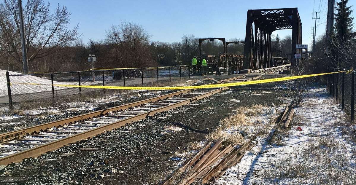 Police in Peterborough, Ont., investigate after a body was found in the Otonabee River near the CP Rail bridge on March 30, 2023.