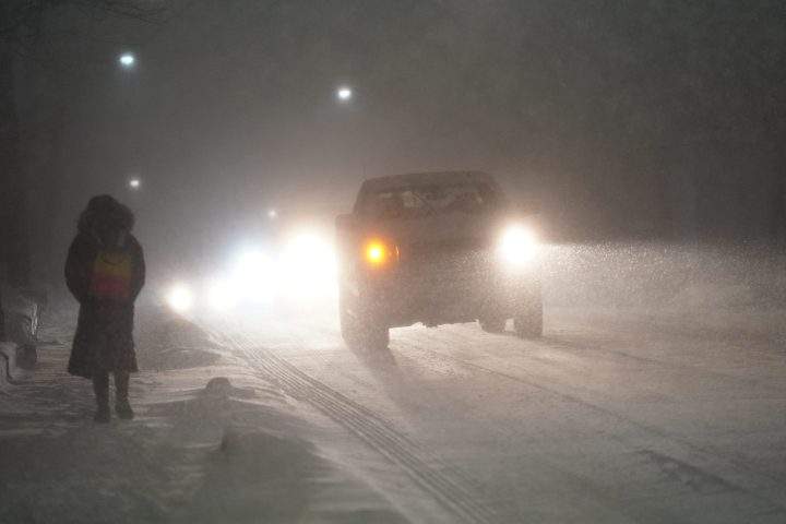 Cars drive during a snow storm in Toronto, Friday, March 3, 2023.