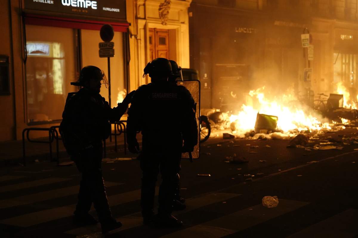 Firefighters put out a fire near Concorde square after a demonstration in Paris