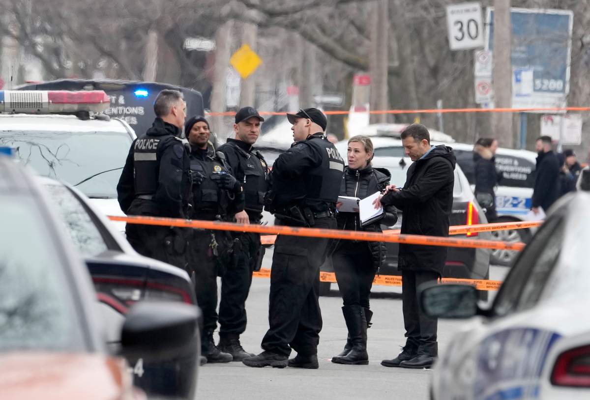 Montreal police attend the scene of a triple stabbing, in Montreal, Friday, March 17, 2023. Montreal police say a suspect is under arrest after three people were found stabbed to death inside an east-end Montreal apartment.