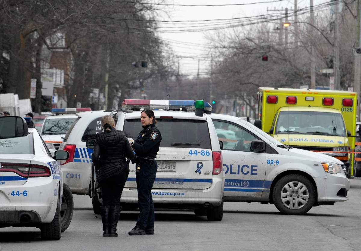 Montreal police attend the scene of a triple stabbing, in Montreal, Friday, March 17, 2023. Montreal police say a suspect is under arrest after three people were found stabbed to death inside an east-end Montreal apartment.