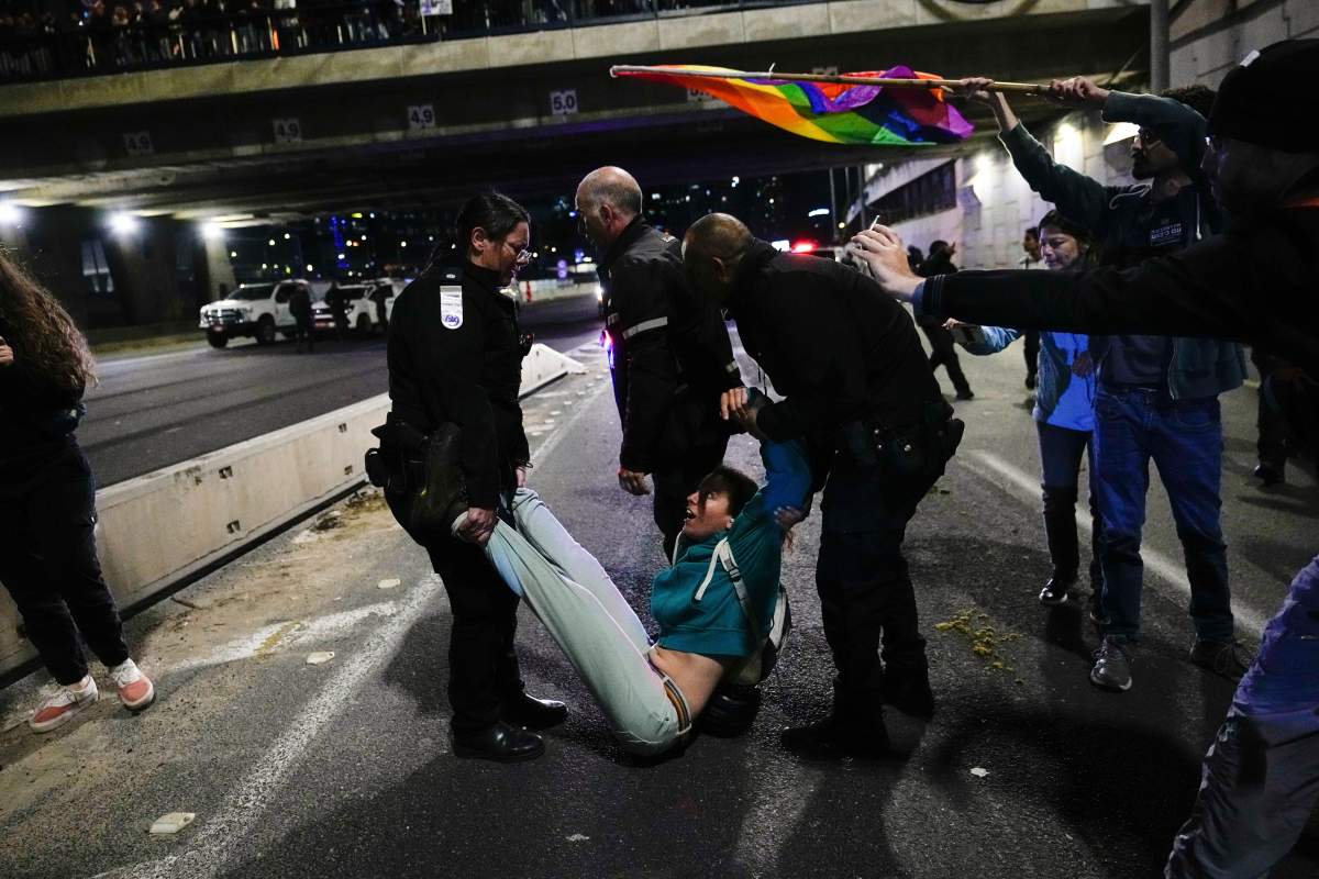 Israeli police officers disperse demonstrators blocking a highway during a protest Saturday against plans by Prime Minister Benjamin Netanyahu’s government to overhaul Israel’s judicial system, in Tel Aviv, Israel. (AP Photo/Ohad Zwigenberg)