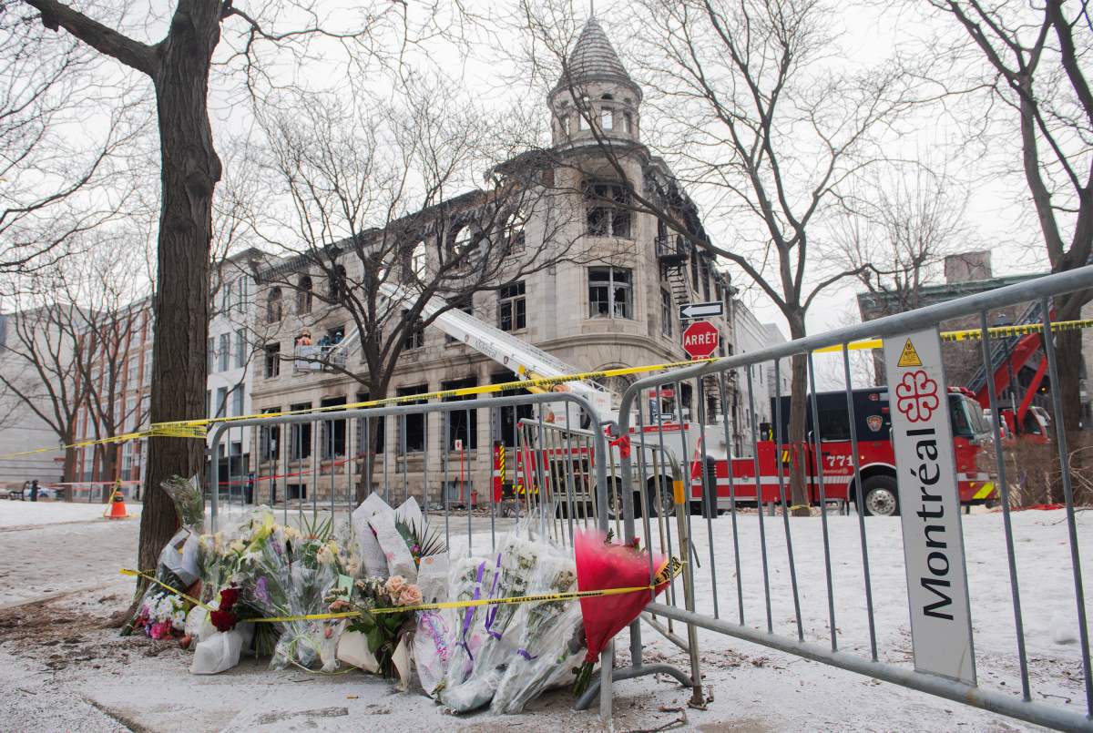 A makeshift memorial is shown at the scene following a fire in Old Montreal, Sunday, March 19, 2023, that gutted a heritage building. Several people are still unaccounted for.