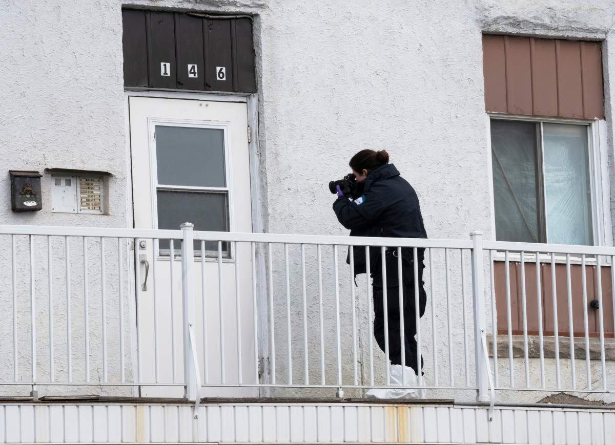 An investigator examines the scene in Louiseville, Que. on Tuesday, March 28, 2023.