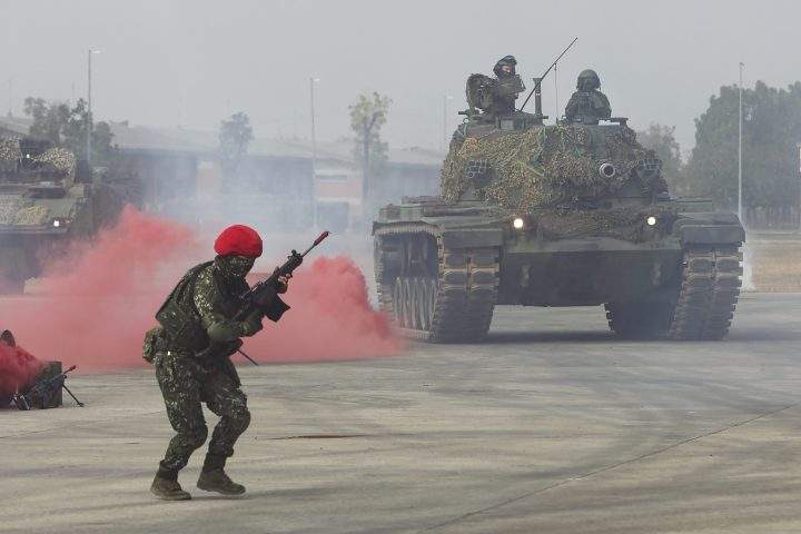 A soldier reacts as a tank approaches during a preparedness drill simulating the defence against Beijing’s military intrusions in Kaohsiung City, Taiwan on Wednesday, Jan 11, 2023.