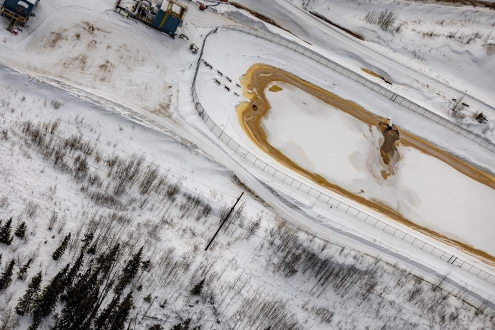 An undated photo of a drainage pond with animal tracks near it at Imperial Oil's Kearl Lake oilsands mine in northern Alberta.