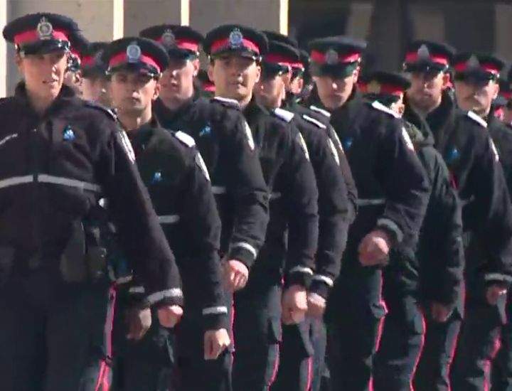 Hundreds of Edmonton police officers, Alberta first responders and other Edmontonians lined the streets of Alberta's capital on Tuesday to pay tribute to two slain constables as their bodies were taken to a funeral home.