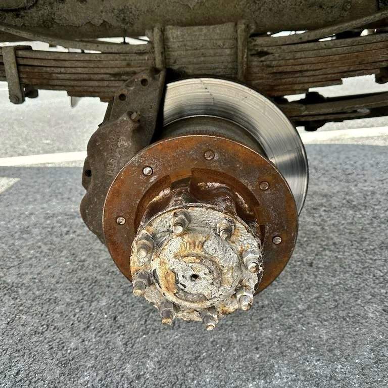 The driver of a commercial vehicle has been charged after a wheel broke off along Highway 404.
