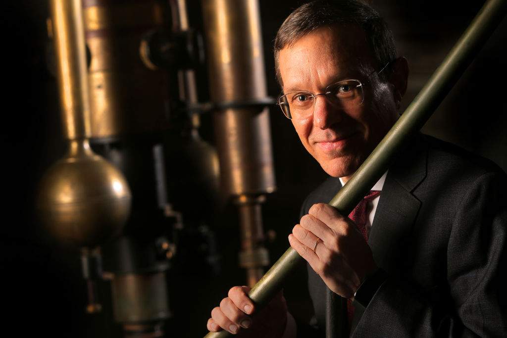 Avi Loeb, the chair of Harvard University's Astronomy Department, poses for a portrait with the 15-inch telescope known as "The Great Refractor," which was installed in 1847, in Cambridge, MA on March 27, 2019.