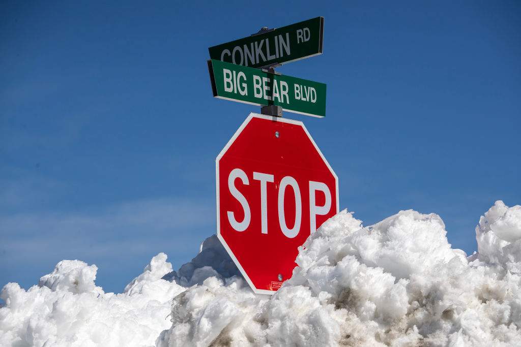 Many street signs are nearly covered as the Big Bear Valley digs out following successive storms which blanketed San Bernardino Mountain communities on Friday, March 3, 2023 in Big Bear Lake, Calif.