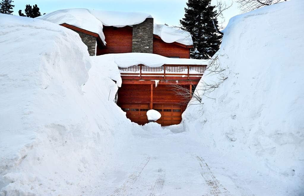 A house is buried by excessive snow in Mammoth Mountain. Over 550 inches of snow has fallen at the main lodge as residents try to dig out.