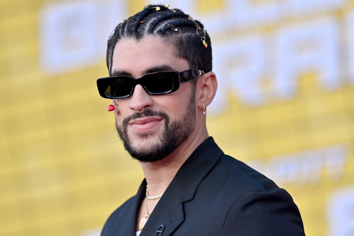 Bad Bunny wearing sunglasses and a sut blazer.