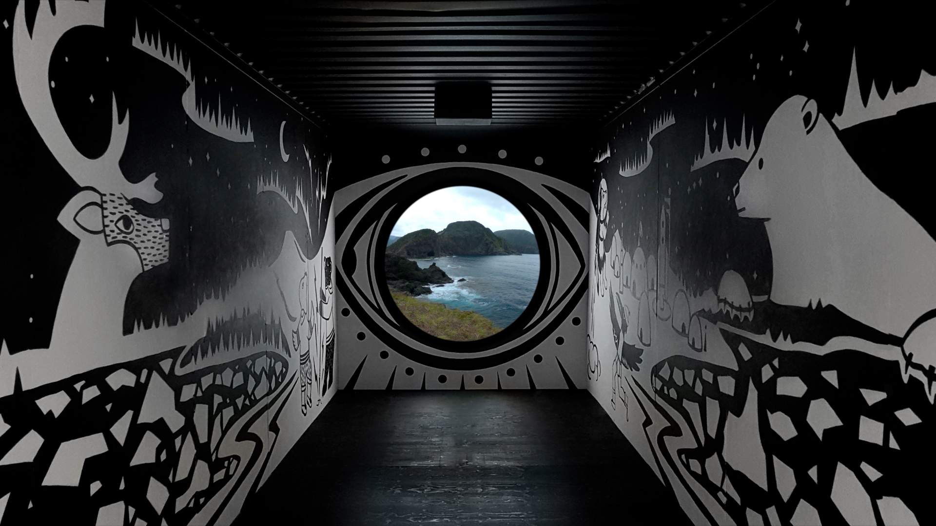 Inside a shipping container, used as a large-scale art installation. It's painted with black and white murals and has a porthole straight ahead, flashing images of the Labrador coastline.