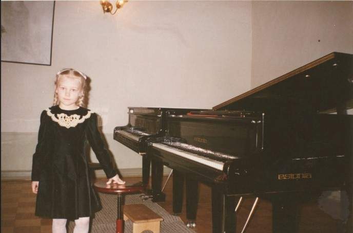 A young Yuliya Andriychuk is seen at piano practice.