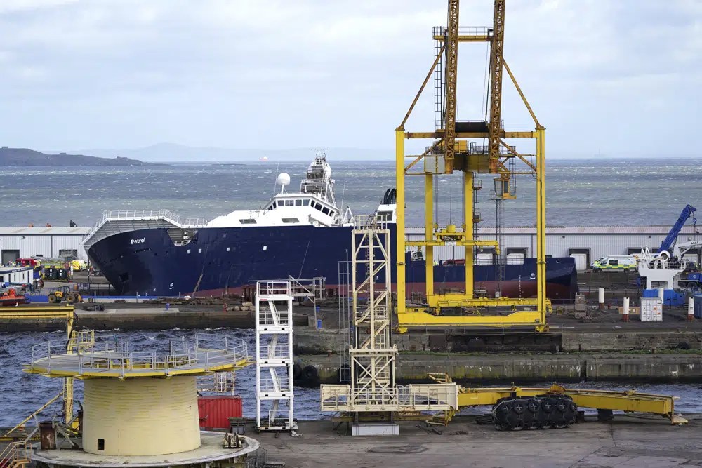Emergency services work at Imperial Dock, where a ship has become dislodged from its holding and is partially toppled over, in Leith, Edinburgh, Scotland, Wednesday March 22, 2023.