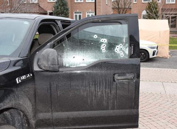 Bullet holes are seen in a window of the pickup truck the officers were using.