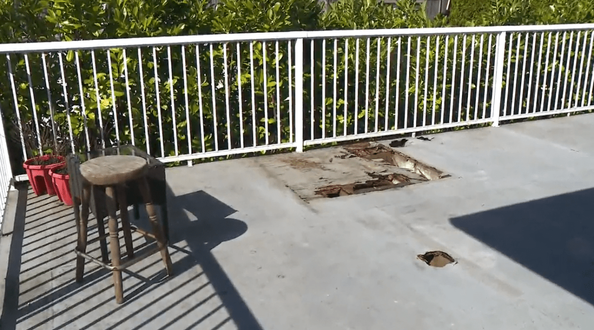 Two of several holes in the floor of Yaser Hamdo's Edgar Avenue home in Coquitlam, B.C. are seen on Mon. March 27, 2023.