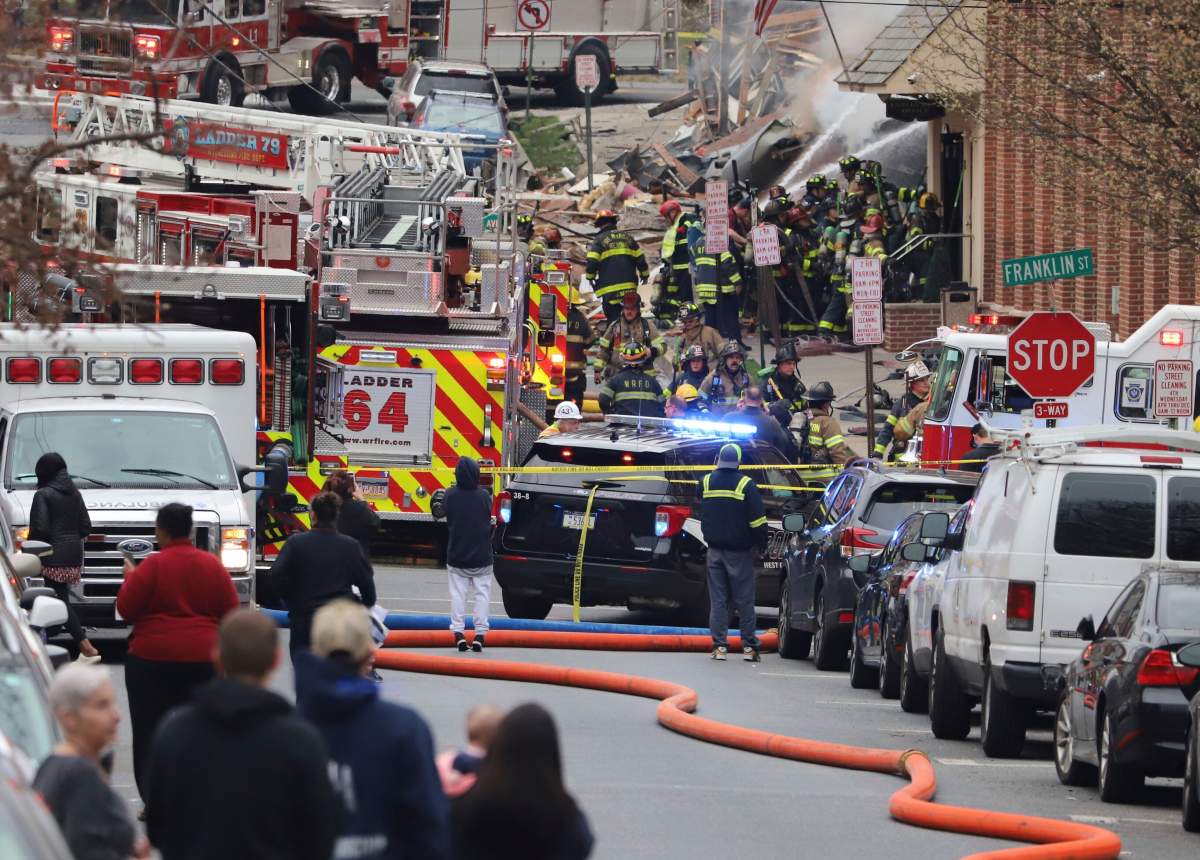 Crowds of first responders swarm the site of a deadly explosion at a chocolate factory in West Reading, Pa., Friday, March 24, 2023. (Jeff Doelp/Reading Eagle via AP)