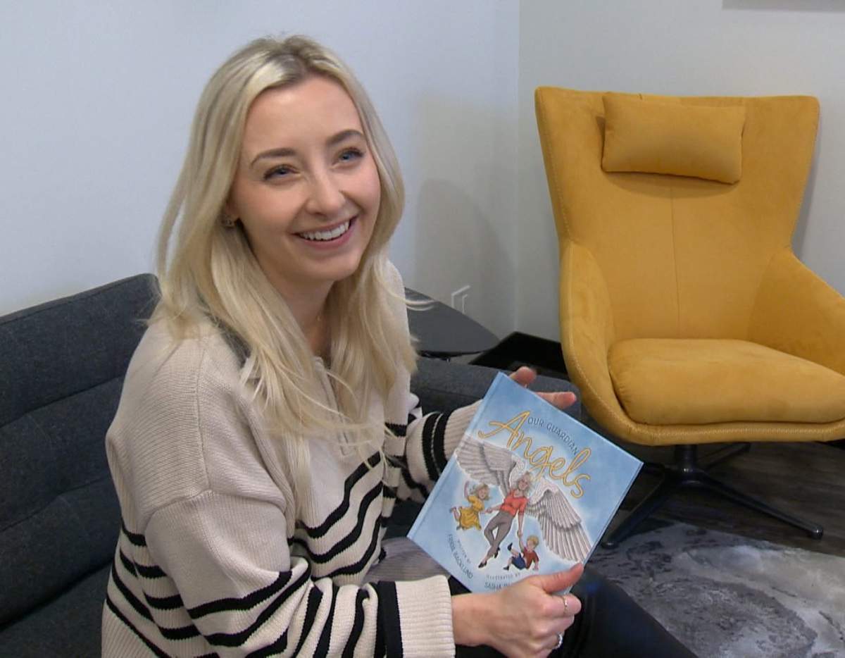Frida Backlund holds the book she wrote to help kids and families with losing loved ones.