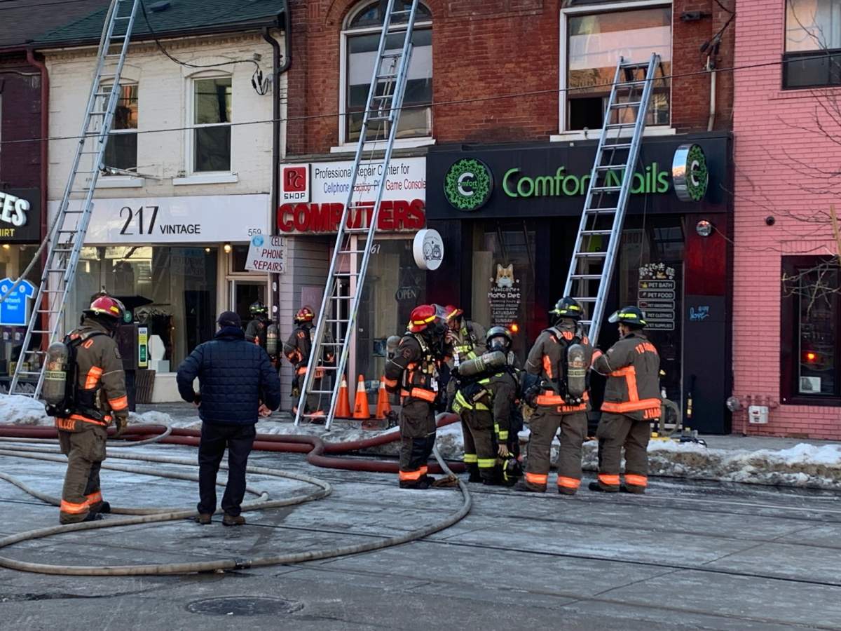 Firefighters battling fire on Queen Street West, near Augusta Avenue, on March 15, 2023.