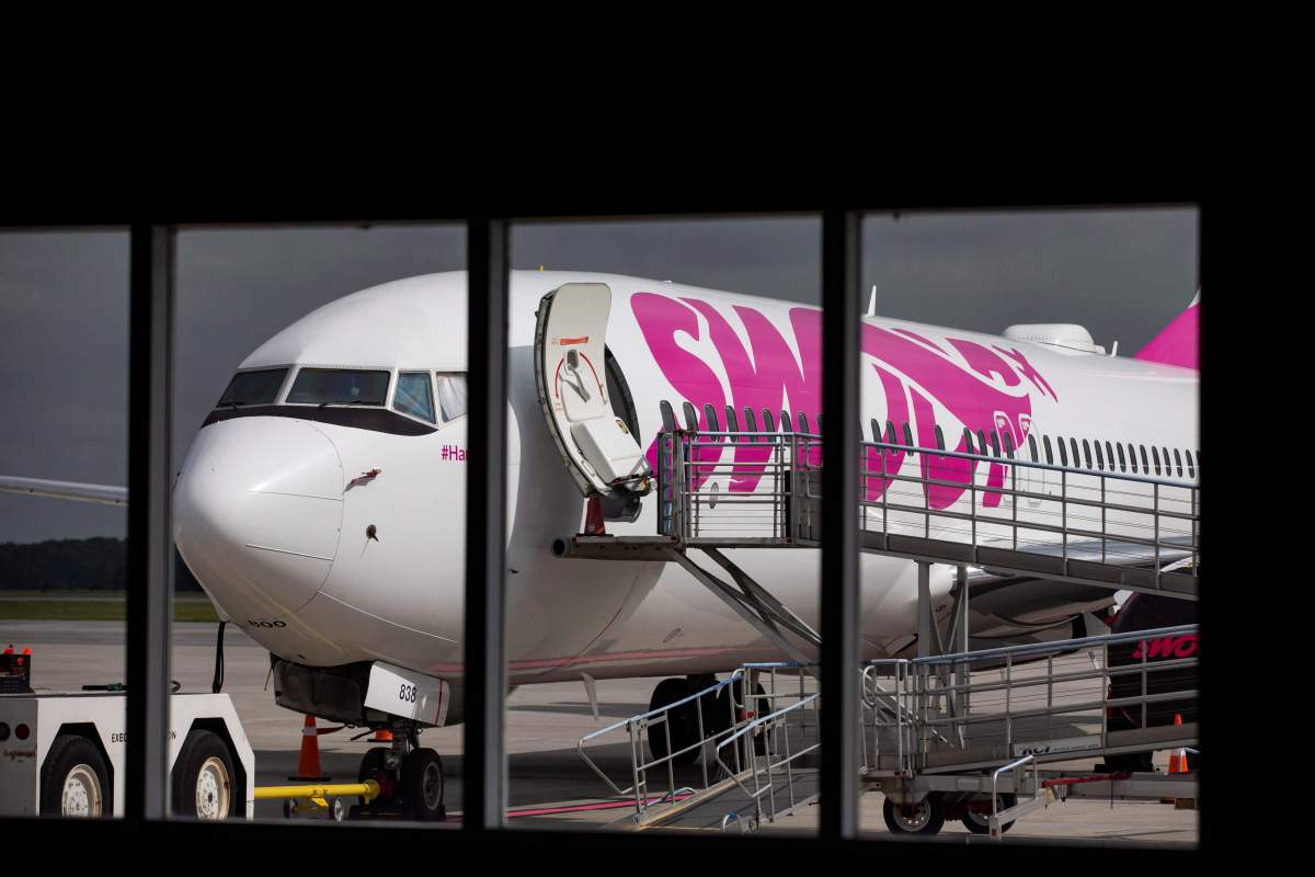 FILE - Swoop Airlines Boeing 737 on display during a media event, Tuesday, June 19, 2018 at John C. Munro International Airport in Hamilton, Ont. 