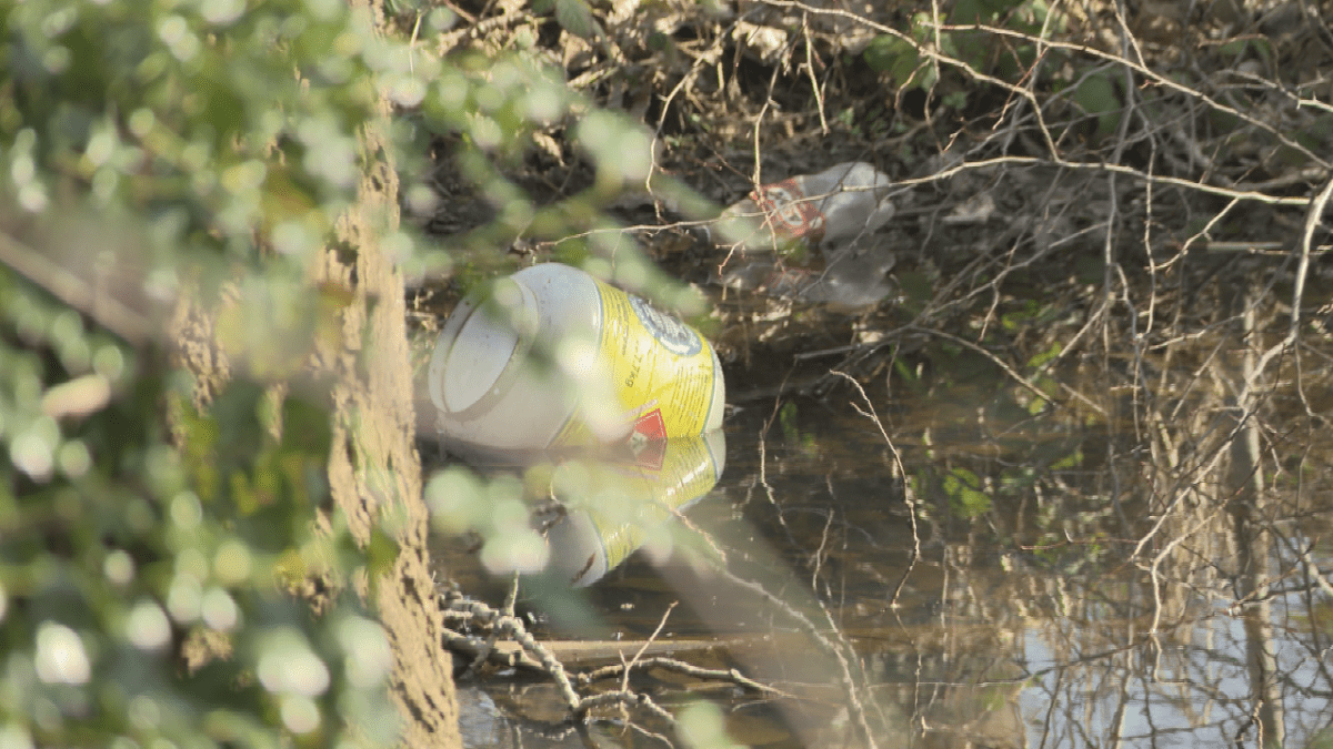 Propane tanks were seen in the water near the encampment.