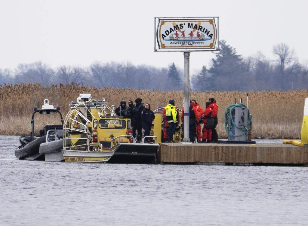 Searchers dock at a marina in Akwesasne, Que., as the search continues for a man missing from the Mohawk community of Akwesasne in an area of the St. Lawrence River where the bodies of eight migrants were recovered in March. THE CANADIAN PRESS/Ryan Remiorz