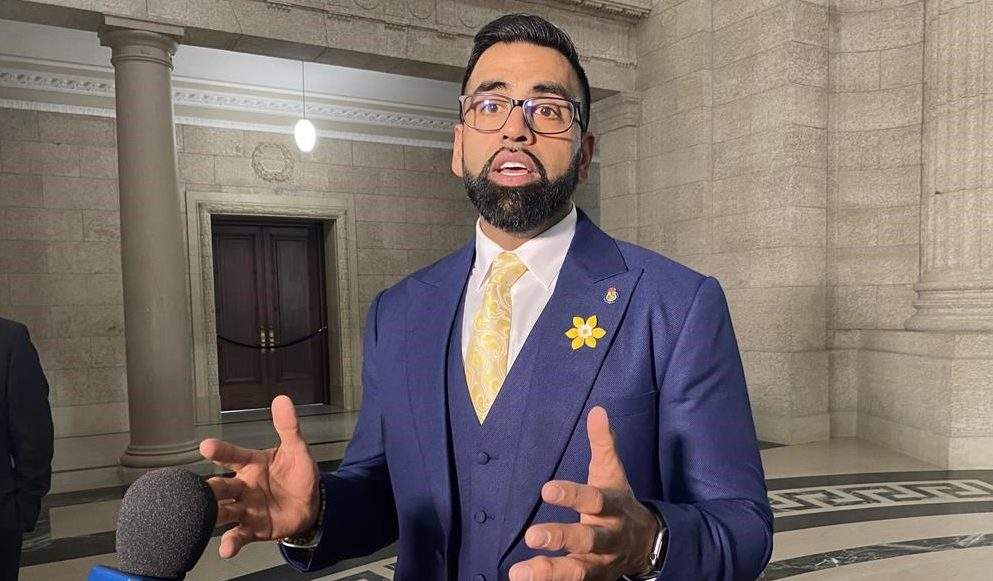 Obby Khan speaks to reporters.