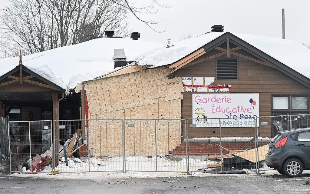The scene outside a daycare centre in Laval, Que., Thursday, Feb. 9, 2023, where a bus crashed into the building, killing two children.