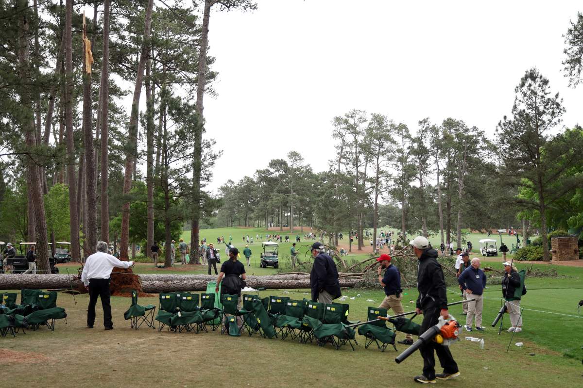 Course officials look over fallen trees on the 17th hole during the second round of the 2023 Masters Tournament at Augusta National Golf Club on April 07, 2023 in Augusta, Georgia.