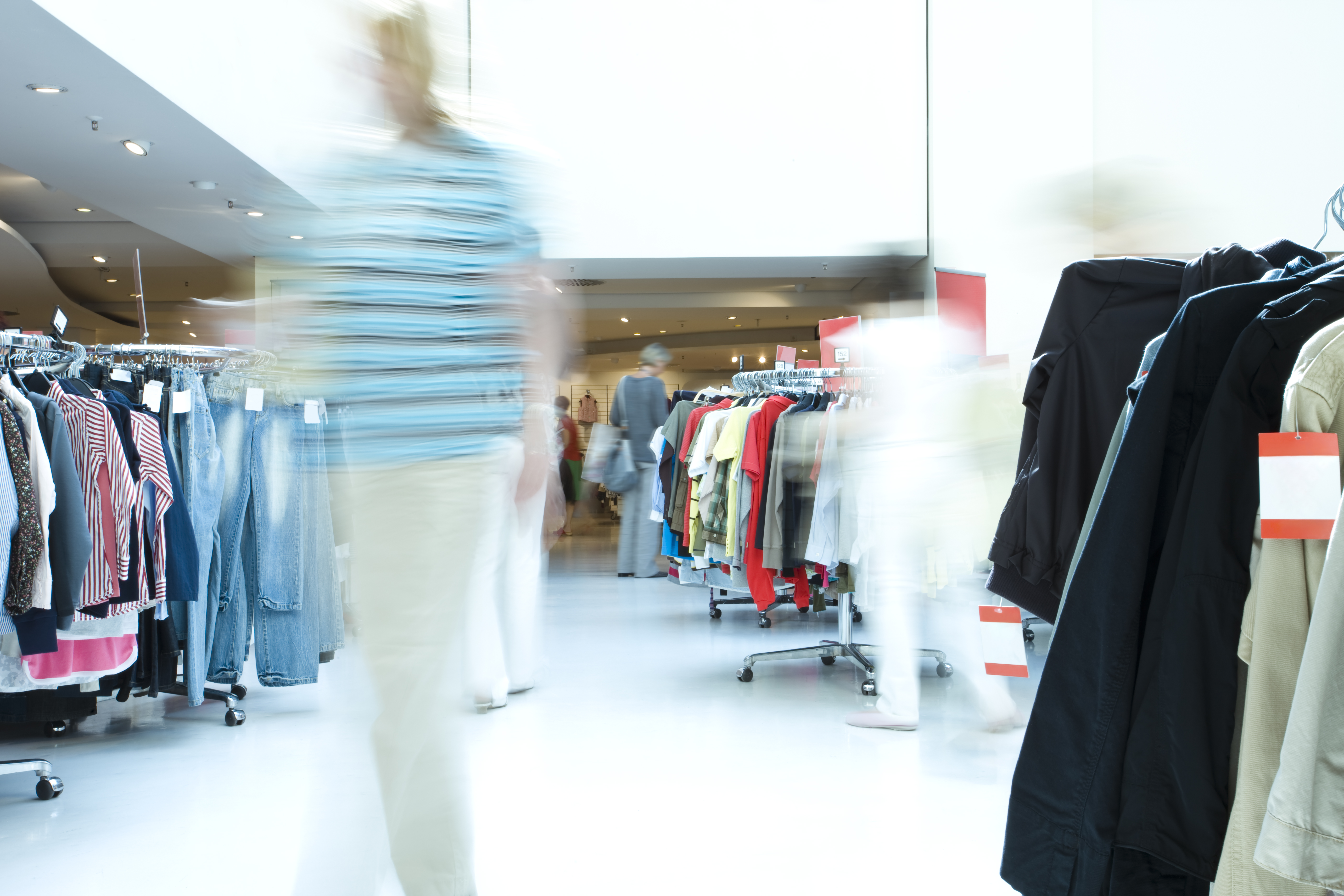 Blurred customer in a clothing store