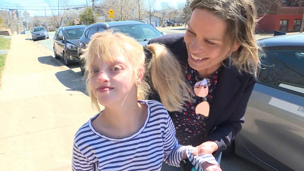 Heather Langley and her daughter Lucy take a walk outside her school.