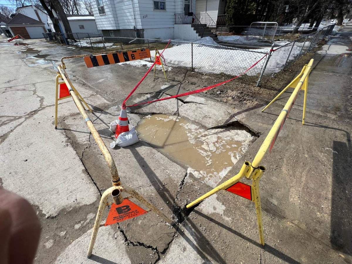 Photo of barricades now up around the sinkhole
