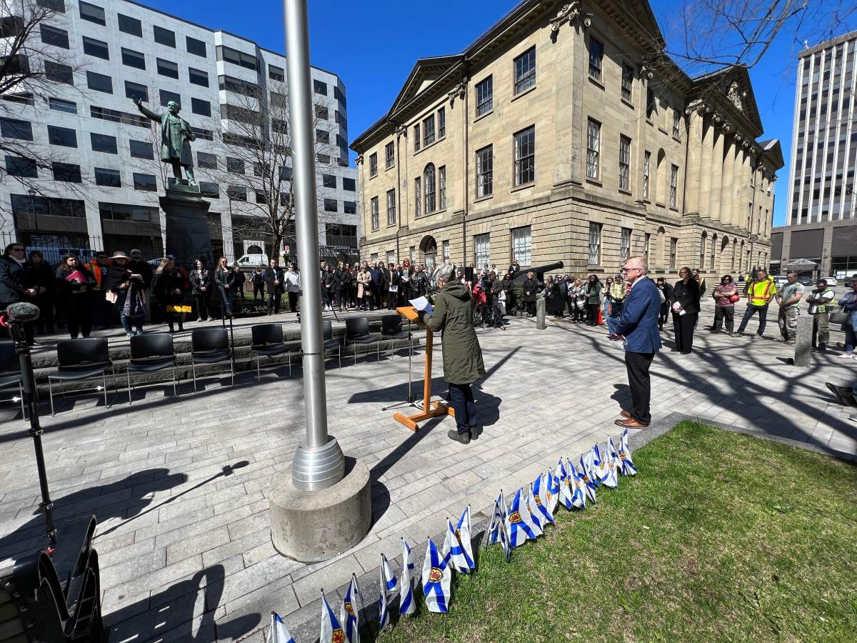 Candace (Candy) Palumbo speaks to the crowd outside Province House on Friday morning. Her husband Tony died from a workplace-related illness in 2014.