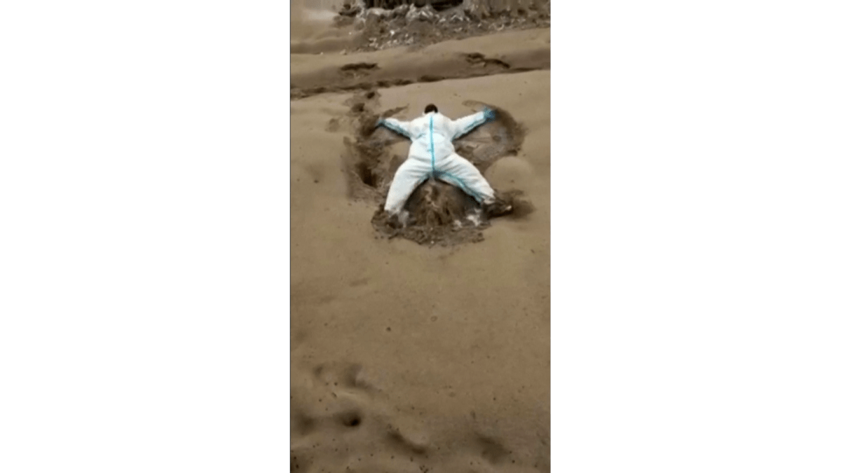 Screengrab from a Reuters video showing a Russian scientist making a snow angel in volcanic ash, following the eruption of a volcano in Russia's far east.