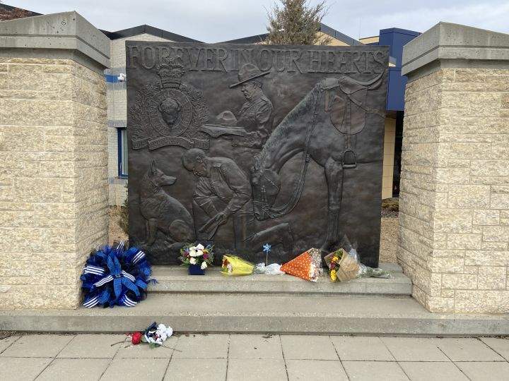A makeshift flower memorial at the cenotaph honouring Cpl. Jim Galloway outside the Strathcona RCMP detachment in Sherwood Park on Monday, April 10, 2023.