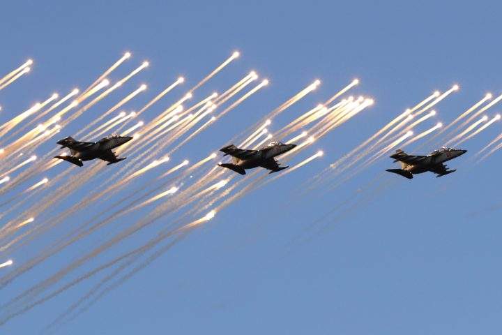 Belarusian army Su-25 jet fighters fly during a parade