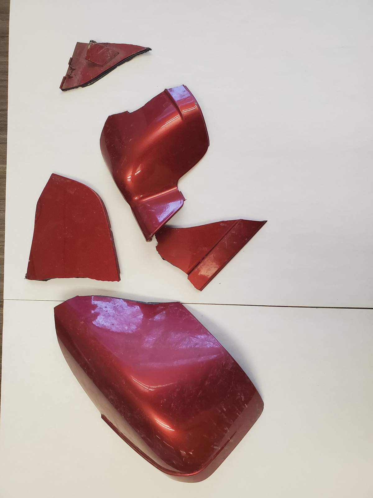 Debris recovered at the scene where a man was hit and killed by a car. It is believed to be from a 2007-2012 burgundy Ford Fusion.