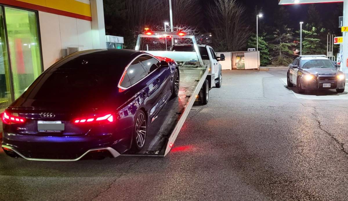 A car being towed after reportedly clocking double the speed limit on Highway 401 in Toronto in a tweet posted on April 9, 2023.