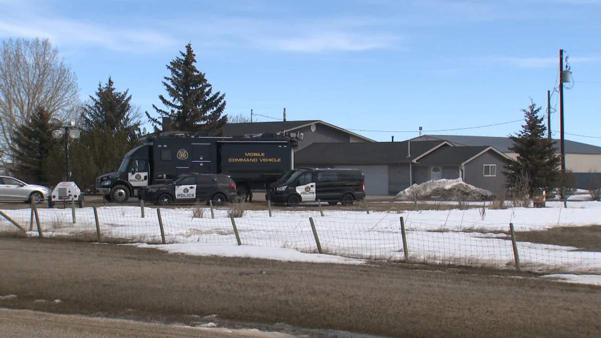 Calgary police vehicles are seen at an acreage east of Chestermere, Alta., on April 7, 2023.