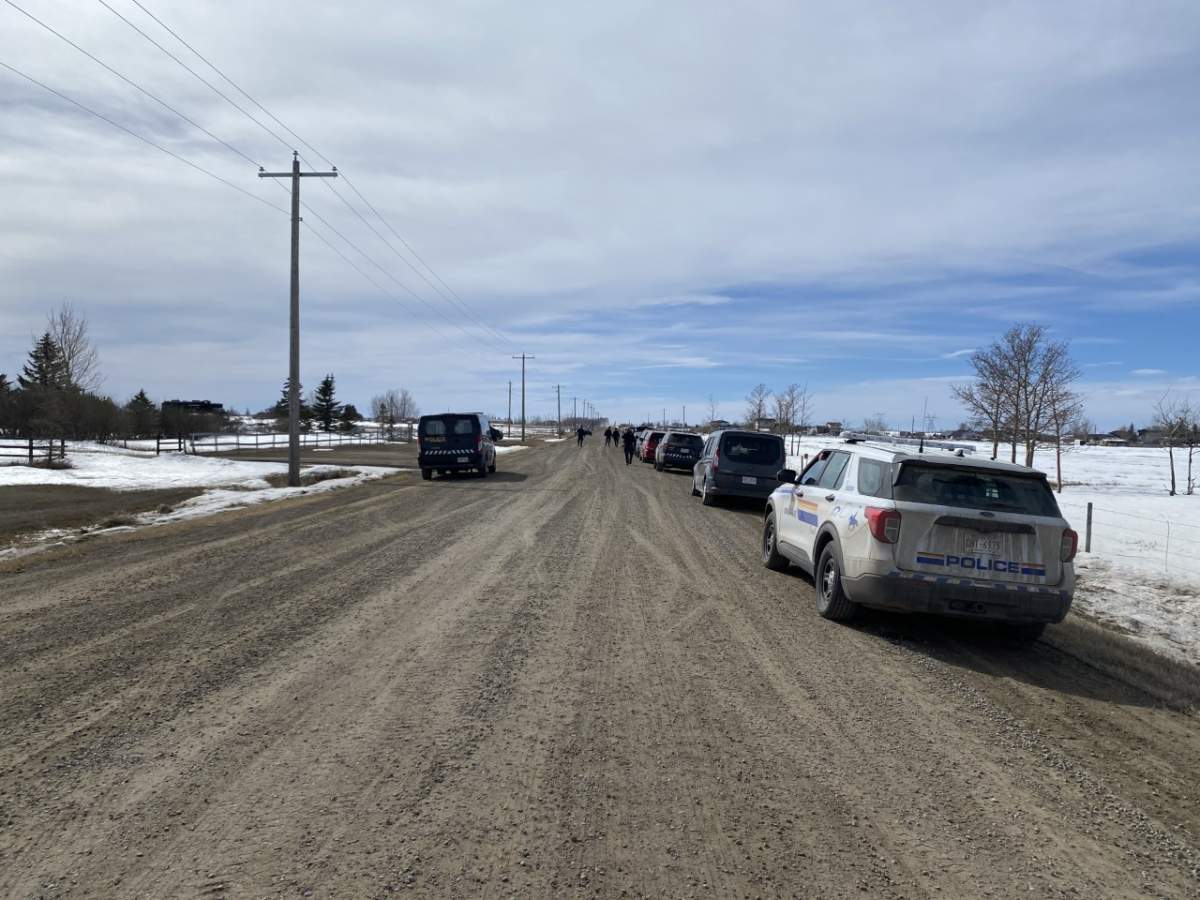 Police vehicles parked near an acreage east of Chestermere, Alta., on April 7, 2023.