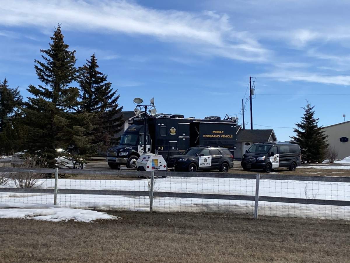 Calgary police vehicles are seen at an acreage east of Chestermere, Alta., on April 7, 2023.