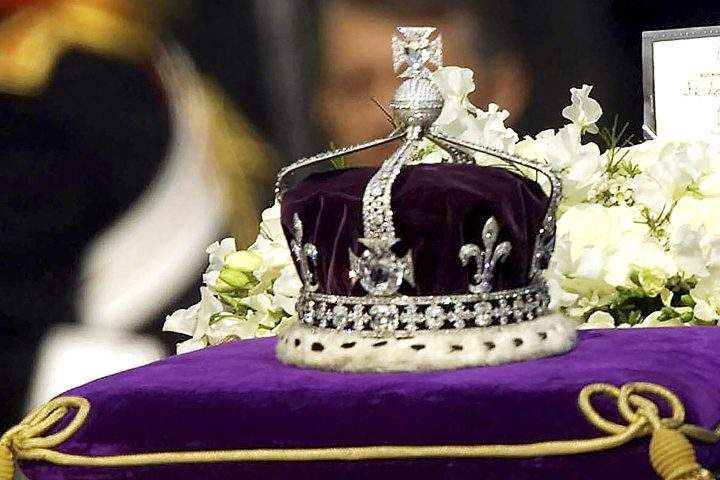 FILE – In this April 5, 2002 file photo, The Koh-i-Noor, or “mountain of light,” diamond, set in the Maltese Cross at the front of the crown made for Britain’s late Queen Mother Elizabeth, is seen on her coffin as it is drawn to London’s Westminster Hall.